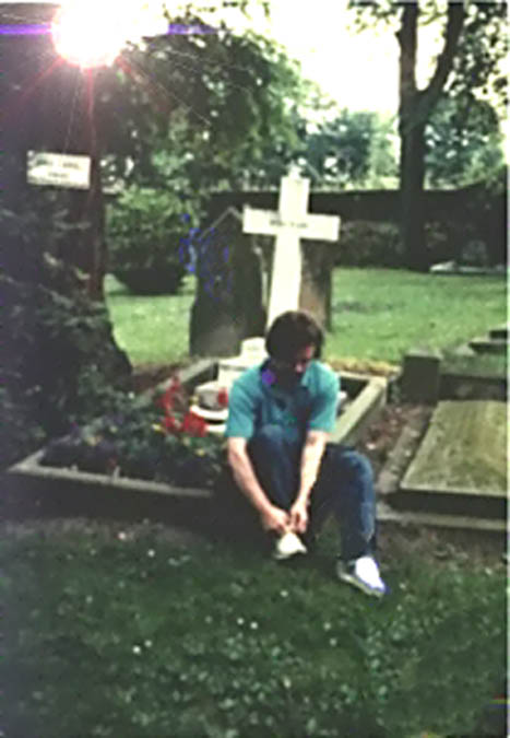 Poet tying his shoes at C S Lewis' grave